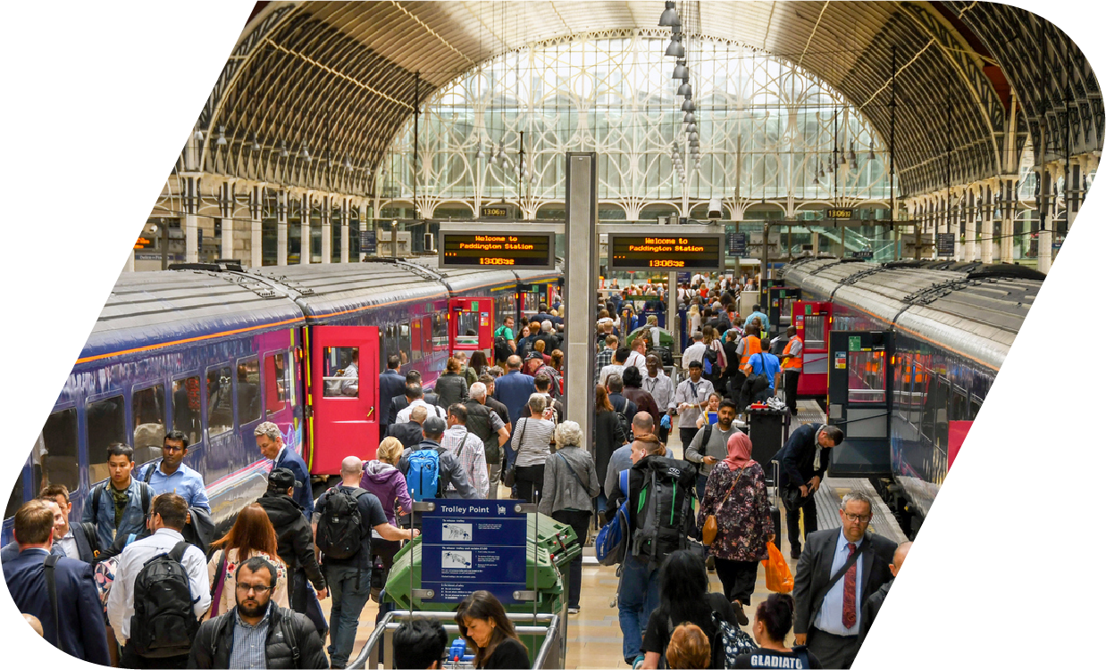 Commuters boarding a train at a busy train station.