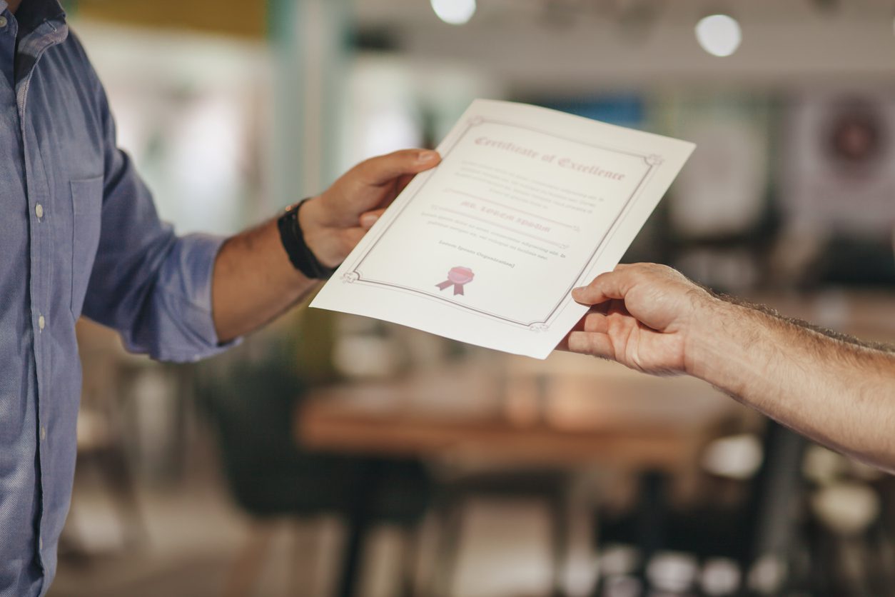 Cropped Hands Of Businessman Holding Certificate