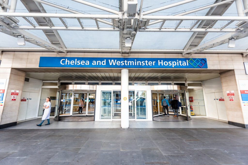 Neighborhood District Of Chelsea, Street, Modern Architecture, Sign For Westminster Hospital Entrance Doors, People