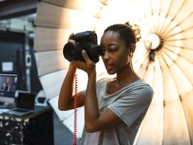 Young Photographer Standing In Front Of A Reflective Umbrella