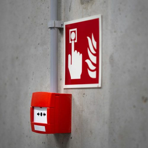 Emergency fire button against a wall.