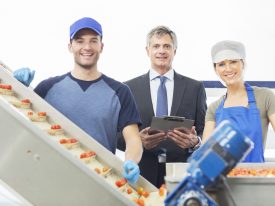 Portrait Of Supervisor And Workers In Food Processing Plant