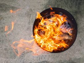 Close Up Paper Burning In Flame. Burning Paper In The Metal Bin.