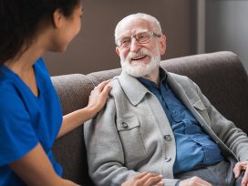 Elderly Man having a discussion with a nurse.