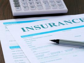 Insurance Form, Calculator And Pen On The Table