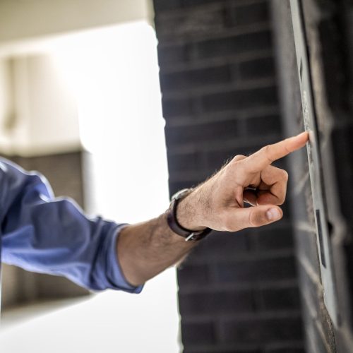 Pressing Buzzer At Modern Residential Building